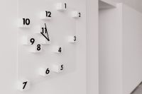 Kaboompics - Modern White Wall Clock with Raised Number Blocks in a Minimal Interior