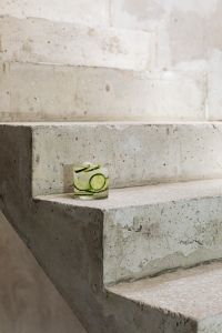 Kaboompics - Small Glass of Cucumber-Infused Water on Concrete Stairs, Wide Vertical Summer Background with Copy Space