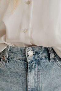 Kaboompics - Close-Up of White Silk Blouse and Light Blue Jeans, Minimalist Women’s Outfit Styling
