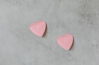 Kaboompics - Two Pink Paper Hearts on Gray Concrete