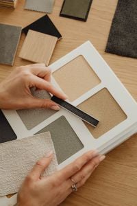 Kaboompics - Close-Up of Hands Comparing Grout and Plaster Samples
