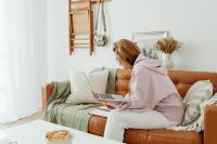 Kaboompics - Woman uses laptop - working from home - writing in the planner