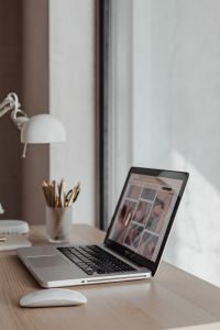 Kaboompics - Home Office Laptop Displaying a Design Website beside Desk Lamp and Colored Pencils
