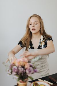 Kaboompics - Young Woman Arranging a Flower Bouquet in a Kitchen Apron