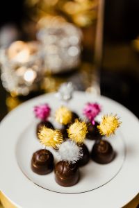 Kaboompics - New Year's Eve Party Dessert Flat Lay with Chocolate Truffles and Colorful Cocktail Picks