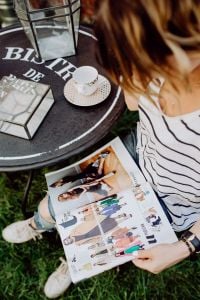 Kaboompics - Woman sitting in a cafe alone and reading fashion magazine