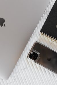 Kaboompics - Smartphone, MacBook and Black 2020 Planner in a Diagonal Desk Flat Lay