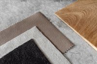 Kaboompics - Neutral Bouclé Upholstery Fabric Swatches Beside a Wood Grain Sample
