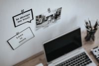 Kaboompics - Motivational Design Quote Cards and Monochrome Street Photo in a Minimalist Laptop Workspace