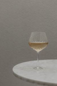 Kaboompics - Raindrops on Wine Glass Against Grey Background