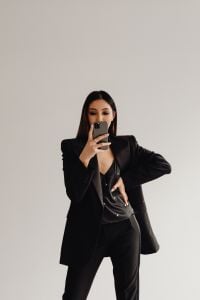 Kaboompics - Businesswoman Holding a Smartphone in a Black Suit