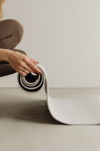Kaboompics - Close-Up of Hand Holding a Rolled Yoga Mat
