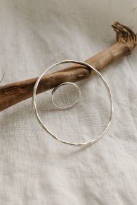 Kaboompics - Silver Circular Bangle on Linen with Driftwood Accent