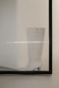 Kaboompics - White Knee-High Boot Behind Ribbed Glass