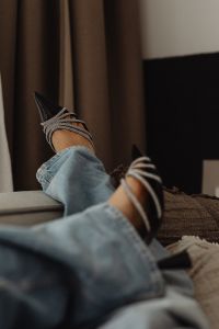 Kaboompics - Relaxed Denim Outfit with Black Heels on a Neutral Lounge Chair