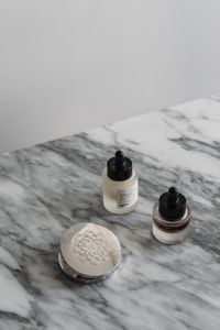 Kaboompics - Cosmetic Bottles, Compact and Toothbrushes on Arabescato Marble