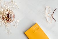 Kaboompics - Orange Book, Eyeglasses And Marble Background