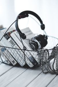 Kaboompics - Detail of Headphones and Book Covers inside a Wire Basket