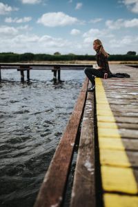 Kaboompics - Beautiful blonde woman on a wooden pier by the lake