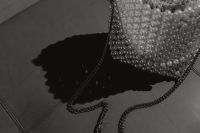 Kaboompics - Cropped Pearl Beaded Evening Bag and Chain on Dark Tile, High-Contrast Shadow
