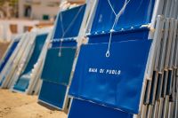 Kaboompics - Blue Baia di Puolo Beach Loungers Lined Up on the Italian Seafront