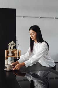 Kaboompics - Woman Reaching for a Coffee Cup in the Kitchen