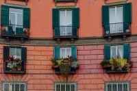 Kaboompics - Orange Tenement Facade With Green Shutters and Window Boxes in Naples