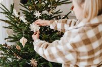 Kaboompics - Person Decorating Christmas Tree with Paper Ornament