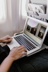 Kaboompics - Unrecognizable man with notebook sitting inside an airplane