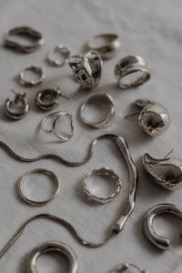Kaboompics - Assorted Silver Jewelry Macro on White Tablecloth