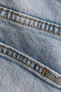 Kaboompics - Diagonal Parallel Topstitching on Faded Blue Denim, Macro Fabric Detail