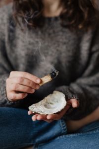 Kaboompics - Soft Smoke Trails against a Gray Sweater during an Indoor Cleansing Ritual