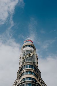 Kaboompics - Vertical Capitol Tower and Schweppes Sign Rising into Deep Blue Madrid Sky