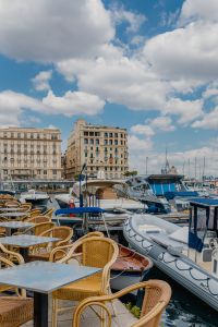 Kaboompics - Outdoor Restaurant Tables Beside Boats in Naples Marina