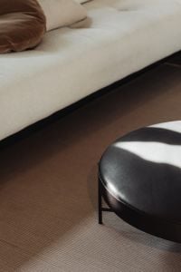 Kaboompics - Modern living space with soft seating and a round black coffee table