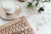 Kaboompics - Wide Desk Flat Lay with Coffee, Wooden Keyboard and Gold Necklace