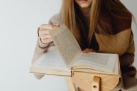 Kaboompics - Woman Reading an Open Book on Her Lap
