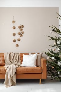Kaboompics - Neutral Living Room with Sofa Christmas Tree and Wall Garland