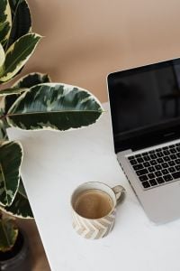 Kaboompics - Close-Up Laptop Coffee Break with Leafy Plant on Marble Table