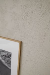 Kaboompics - Textured Beige Plaster Wall and Framed Artwork – Fujifilm X100VI