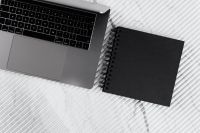Kaboompics - Laptop and Black Notebook on White Ribbed Marble Desk, Minimalist Office Flat Lay