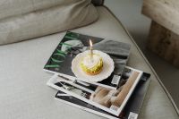 Kaboompics - Small Cake with a Candle on Magazines