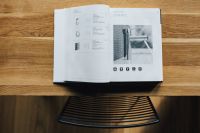 Kaboompics - Open Grohe Bathroom Faucet Catalogue on a Wooden Table, Overhead Product Photo