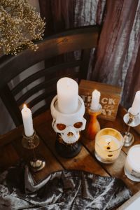 Kaboompics - Overhead Halloween Table with Skull Candle, Candles and Trick or Treat Sign