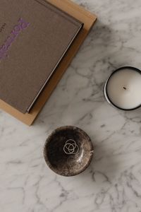 Kaboompics - Overhead Marble Table with Ring Dish, Candle and Art Books