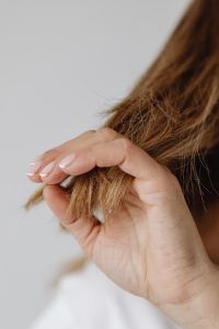Kaboompics - Close-Up of Frayed Hair Ends Held Between Fingers
