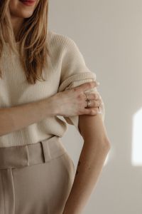 Kaboompics - Woman Adjusting Sleeve in a Neutral Minimalist Outfit