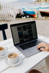 Kaboompics - Laptop and Cappuccino with Boats at a Seaside Cafe