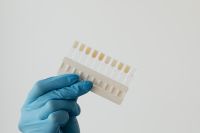 Kaboompics - Gloved Hand Holding Tooth Color Samples