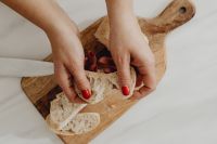 Kaboompics - Bread Slices and Prosciutto on a Wooden Cutting Board
